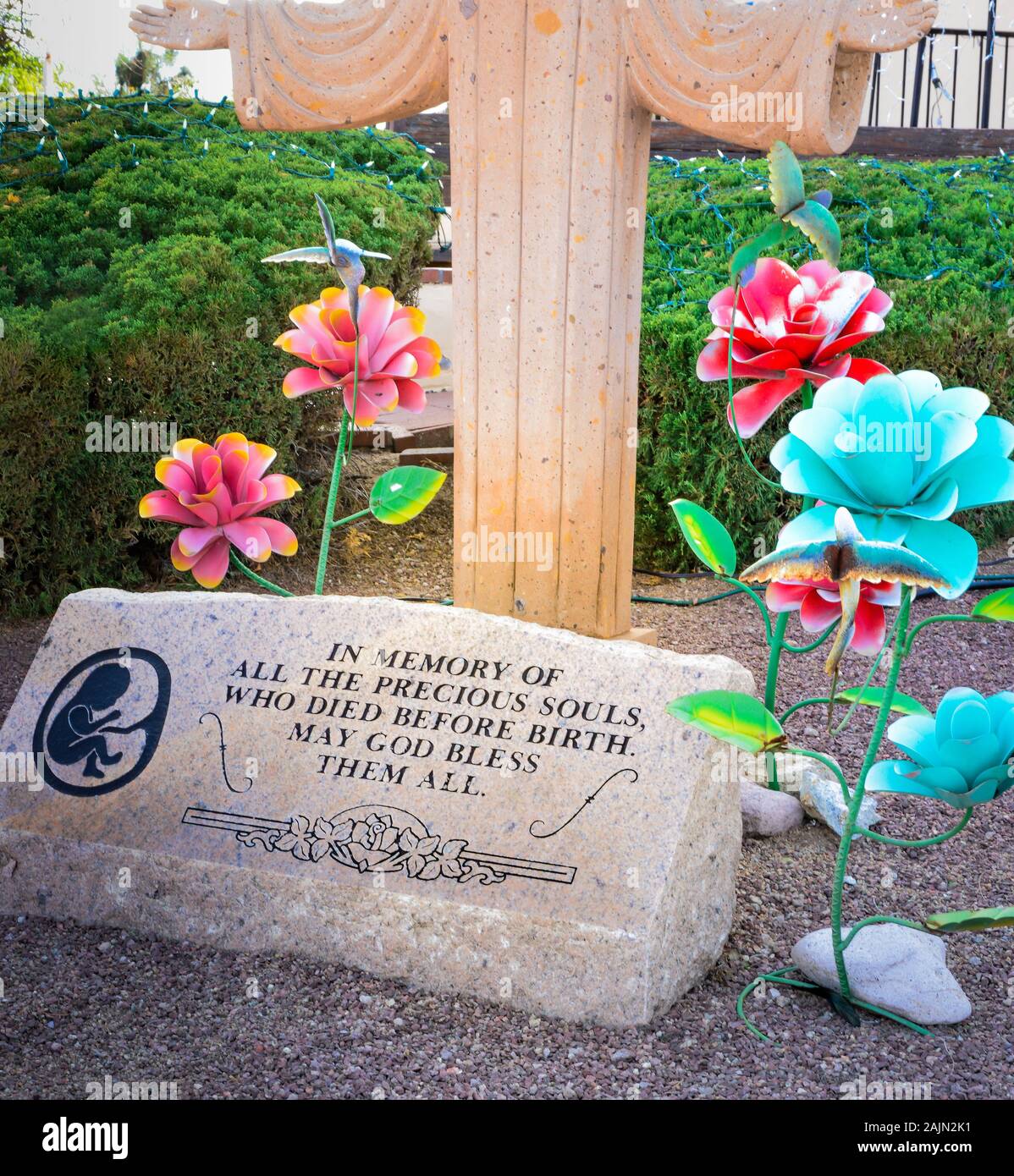 Religious pro life sentiment engraved on a marble headstone with artisan metal flowers, on the grounds of  St. Ann's Catholic church, Tubac, AZ Stock Photo