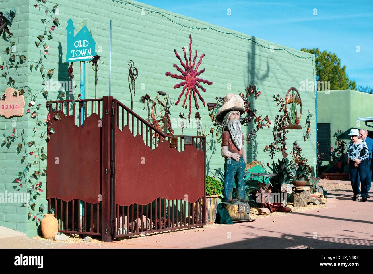 Tourists view the hand carved wooden sculpture of Slim, an iconic