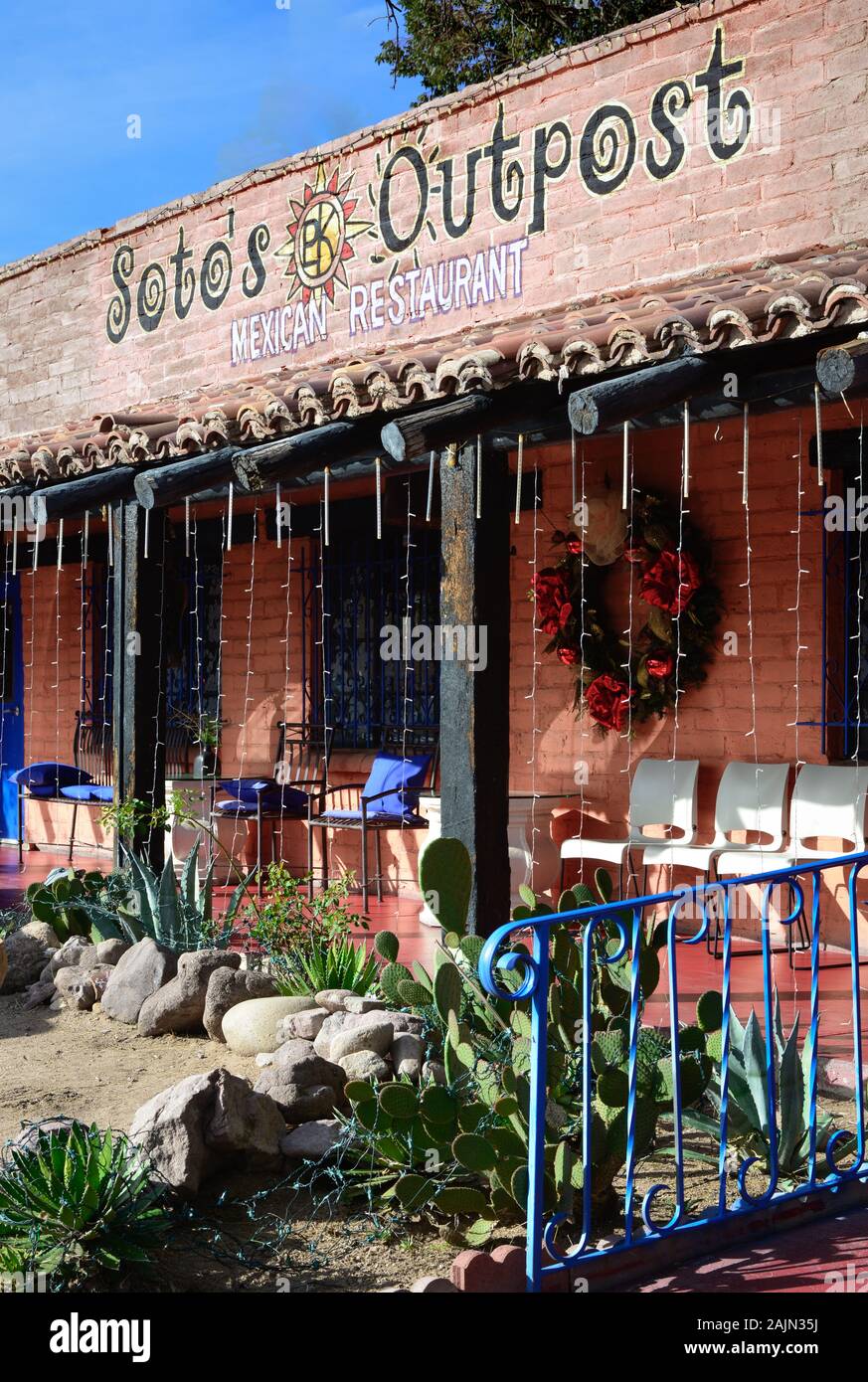A charming old adobe building with porch and cacti garden houses Soto's