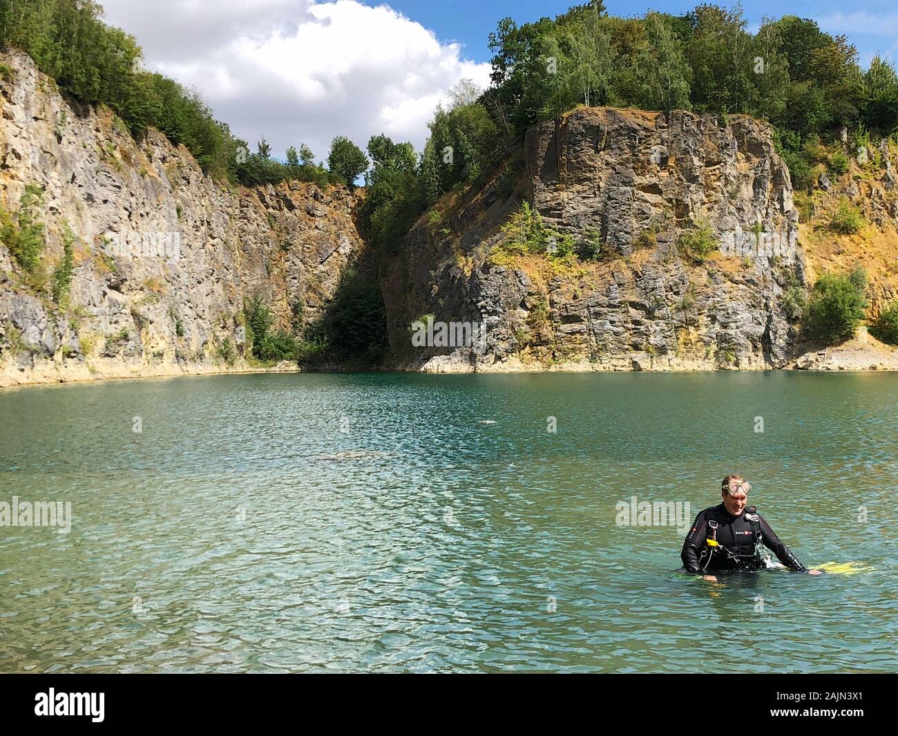 Quarry explored by scuba divers. Flooded quarry for adrenaline hobby