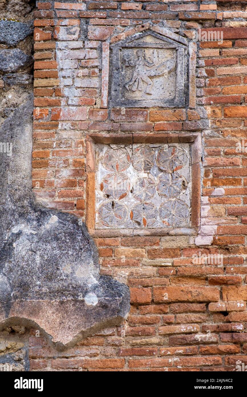 Roman brickwork, carving of phalic erotic art, erect penis on the walls