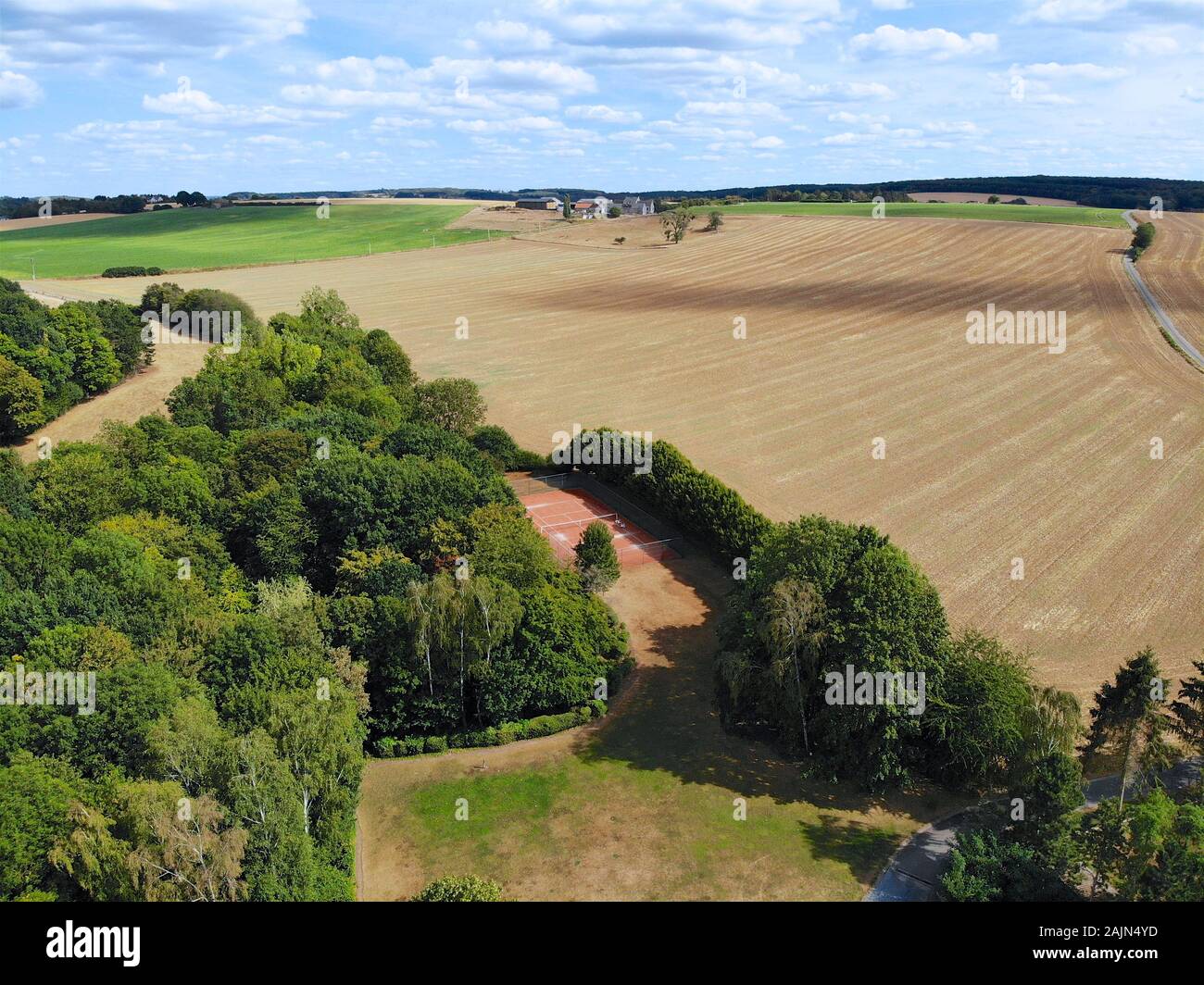 Aerial view of agriculture farmland and and small house during dry summer season, Belgium Stock Photo