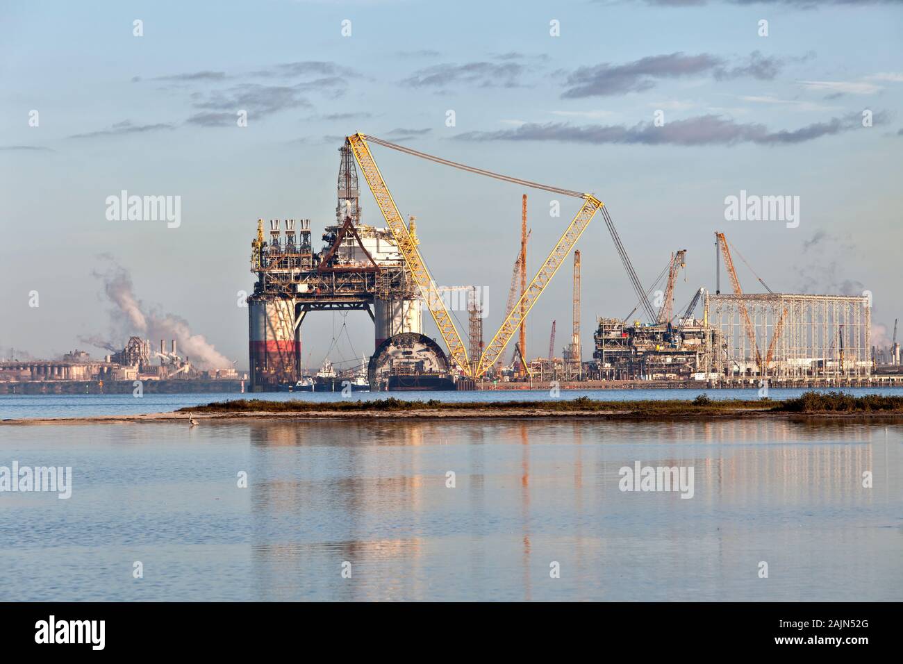 Construction of 'Big Foot' deepwater oil & gas platform nearing completion, swing booms, at dawn, Ingleside Bay. Stock Photo
