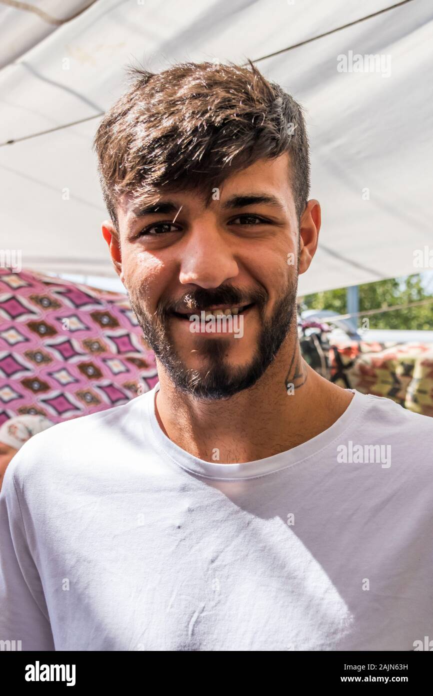 Bodrum, Turkey - September 24th 2019: Young Turkish man smiling for the camera. The town is a popular tourist destination. Stock Photo