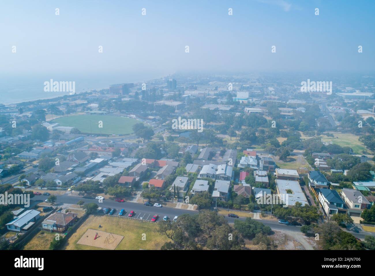 Heavy smoke haze covering suburbs in Victoria, Australia - aerial view Stock Photo