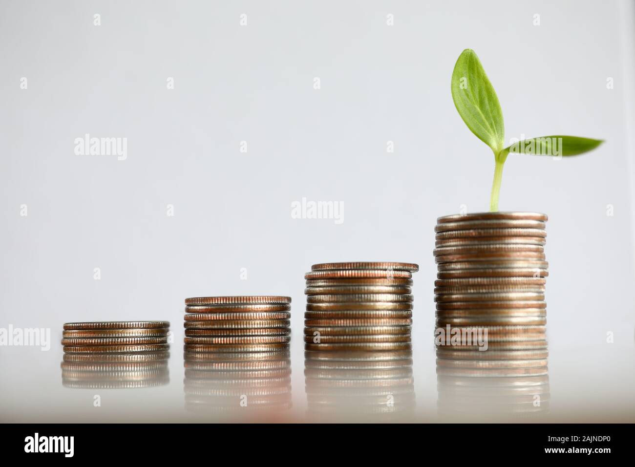 Chart tower with silver metall coin against gray background Stock Photo