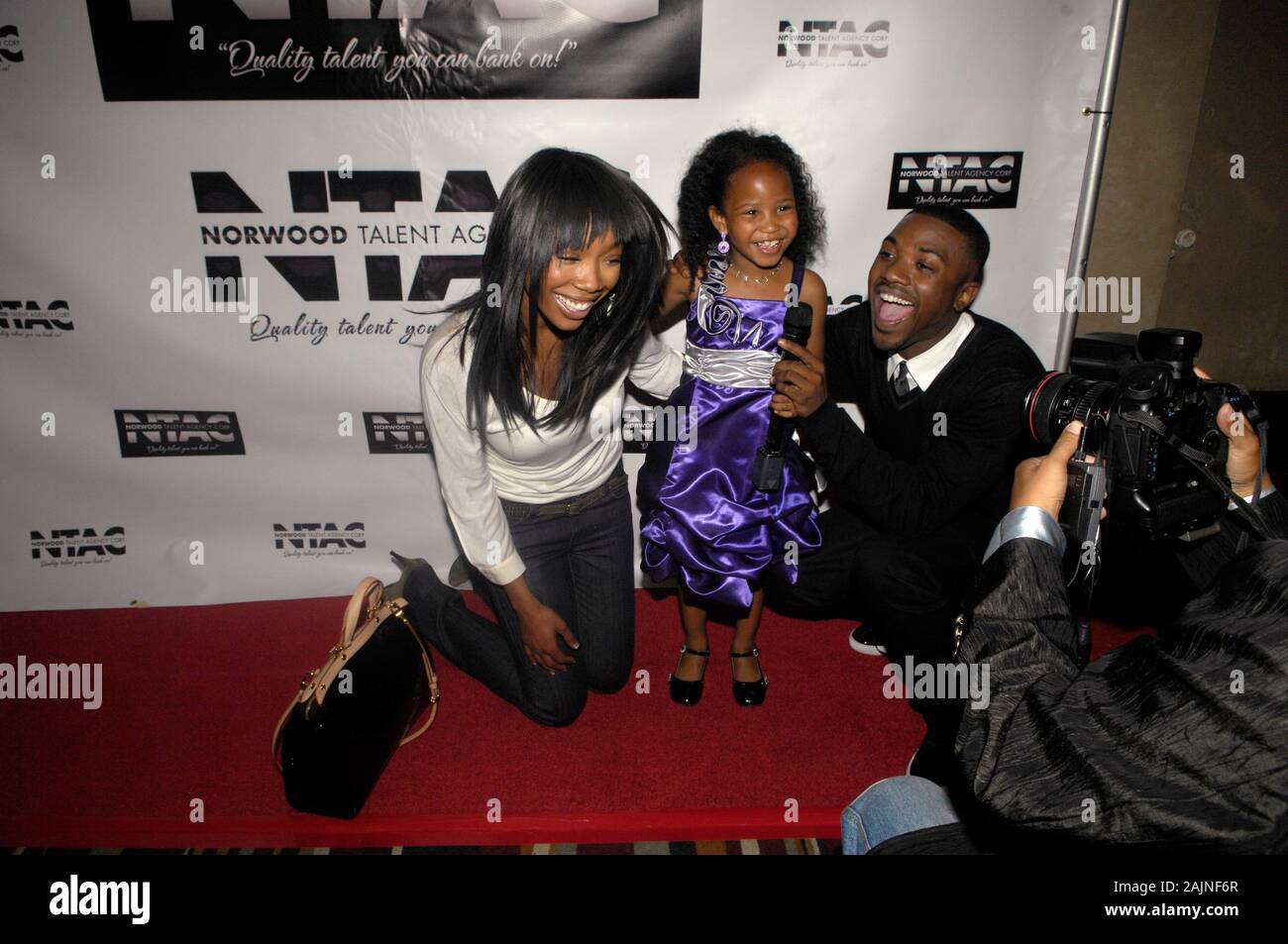 (L-R) Brandy, Harmony Love Bailey and Ray J attend the Norwood Talent Agency Corporation (NTAC) Grand Opening at the Hollywood Roosevelt Hotel on May 10, 2011 in Los Angeles. Stock Photo