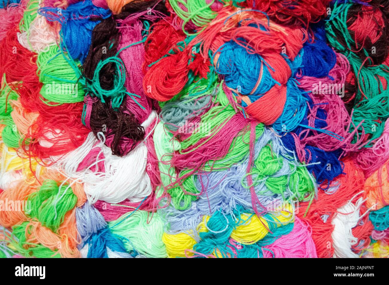 A colourful textured background with skeins of yarn bundled together. Stock Photo