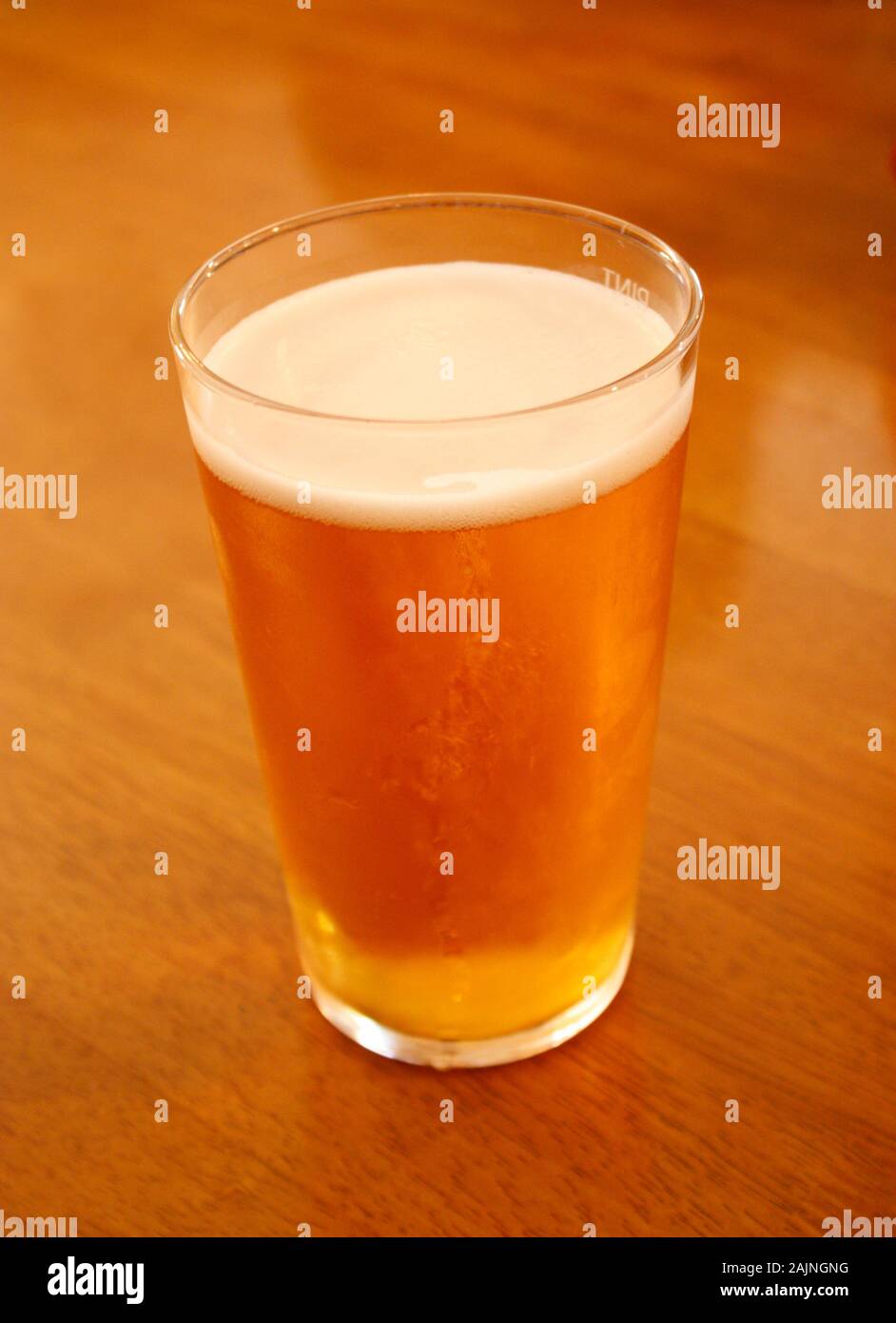 A pint of lager beer served in a thin glass Stock Photo
