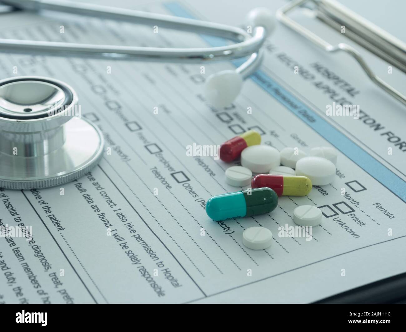 pill-with-stethoscope-medical-record-application-form-on-physicians