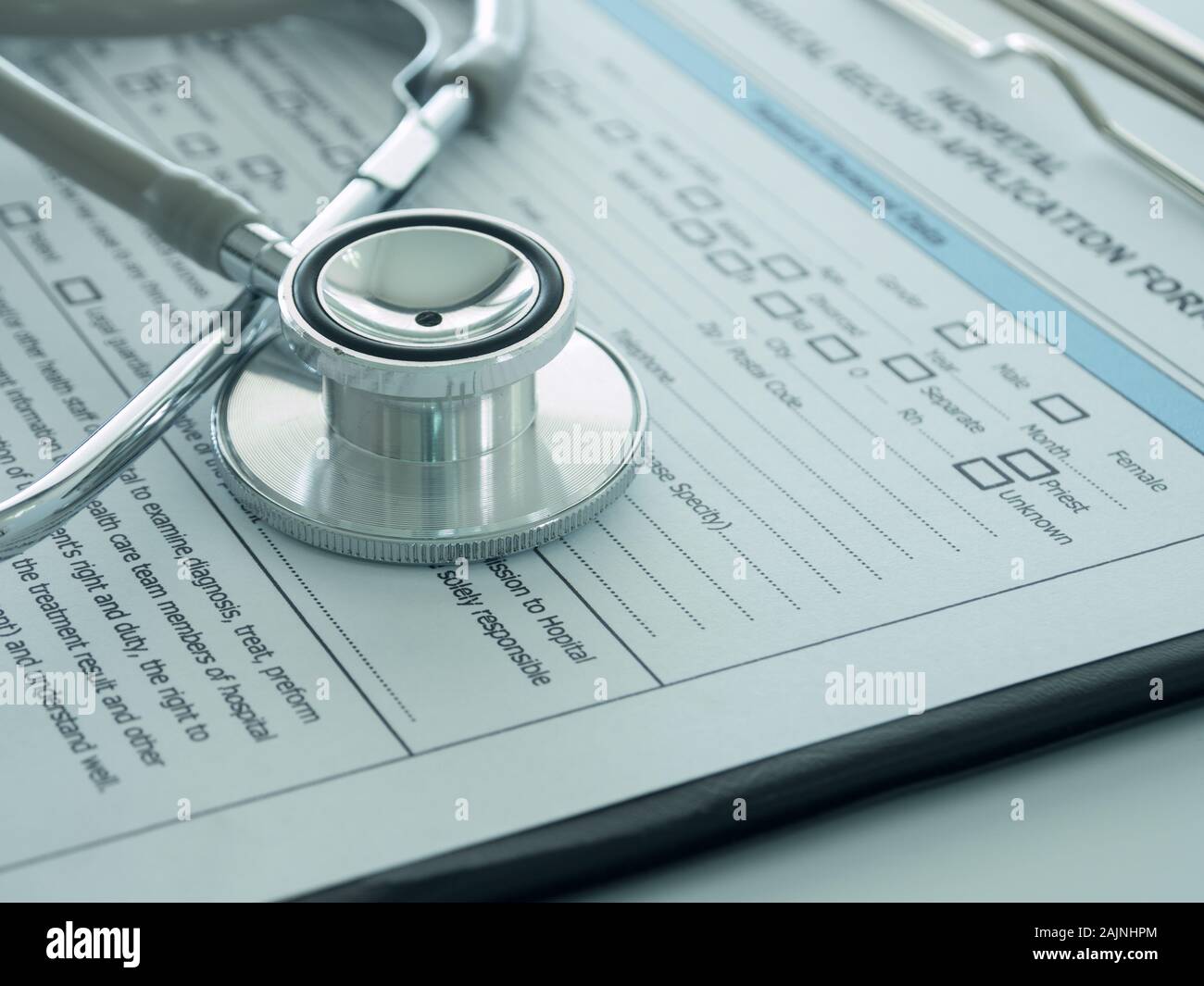 stethoscope with medical record application form on physicians desk