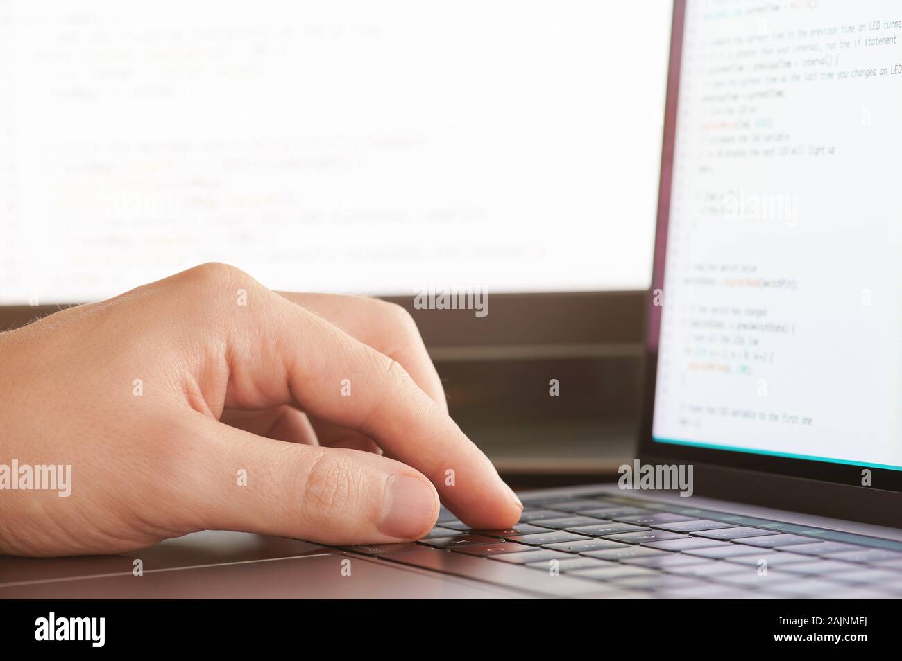 Coding application theme. Programmer man hand on laptop keyboard Stock Photo
