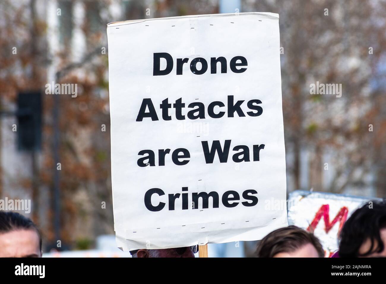 January 4, 2020 San Jose / CA / USA - Close up of Drone Attacks are War Crimes sign raised at the anti-war protest in front of the Cityhall in downtow Stock Photo