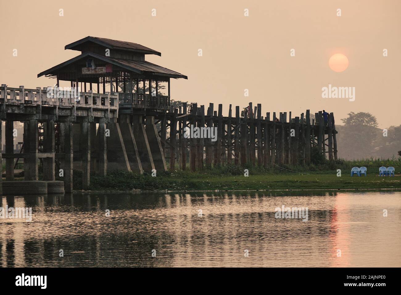 Ancient U Bein Bridge over the Taungthaman Lake in sunrise. The bridge ...