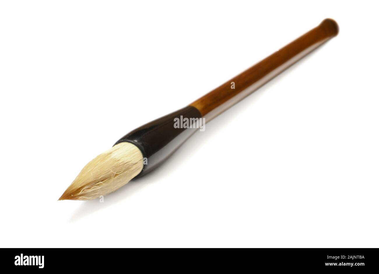 Traditional Chinese calligraphy brush lying on a white background Stock Photo