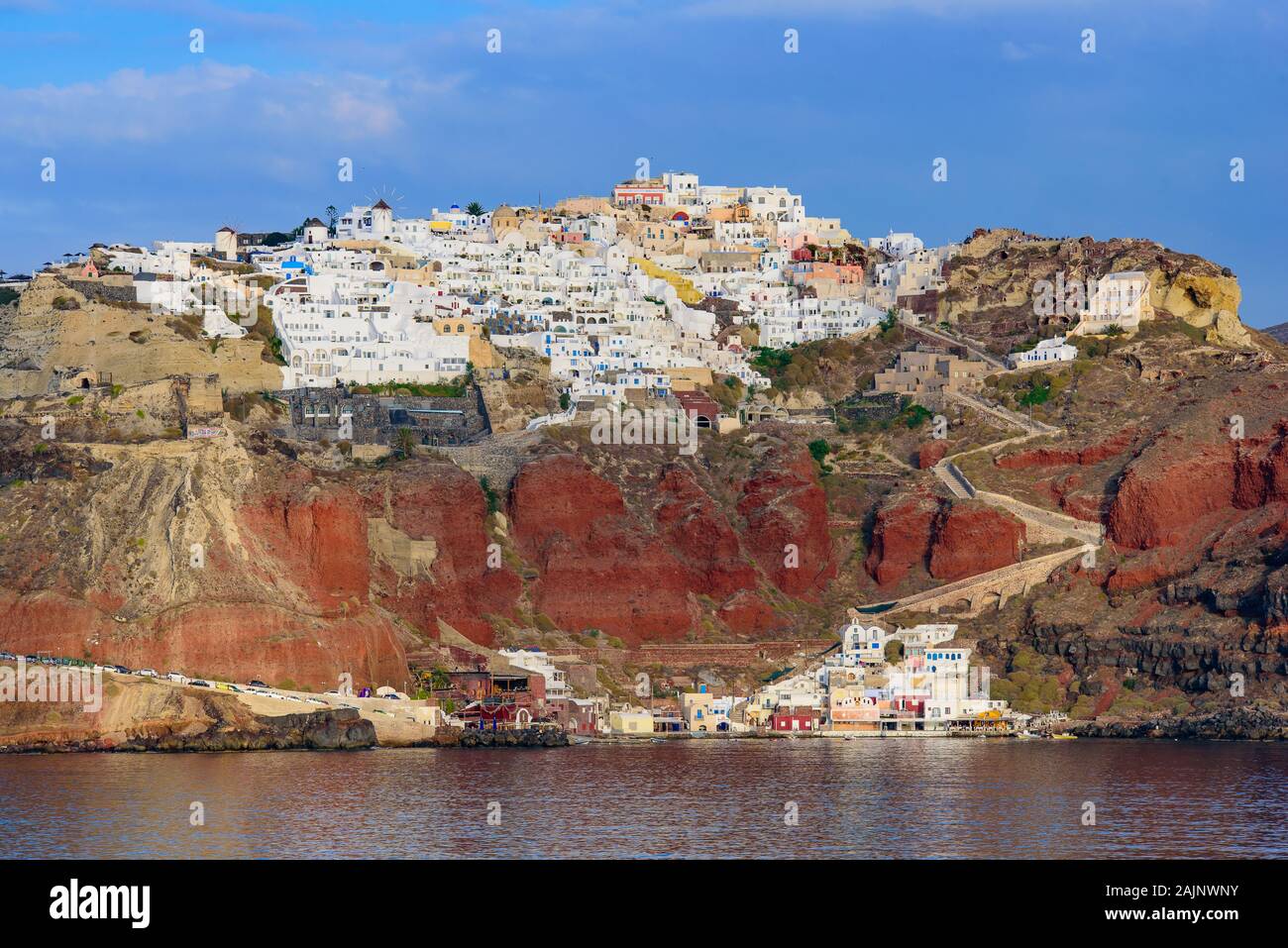 View of the white buildings of Oia village from Aegean Sea, Santorini, Greece Stock Photo