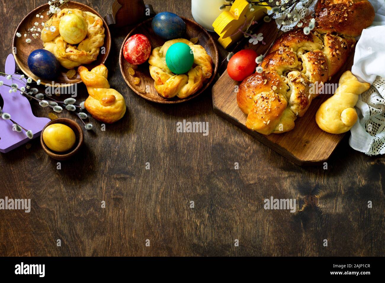 Easter holiday table. Easter cakes and colored eggs on a wooden table. Top view flat lay background. Copy space. Stock Photo