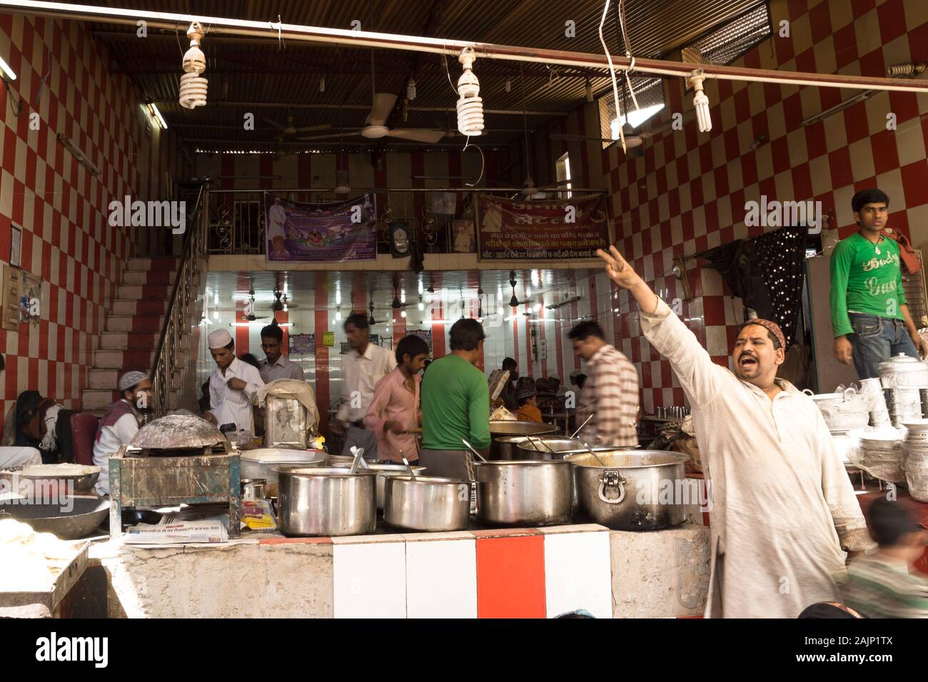 Ajmer, Rajasthan, India - 12 March 2012: Man screaming in front of local kitchen of Indian food stall at the market Stock Photo