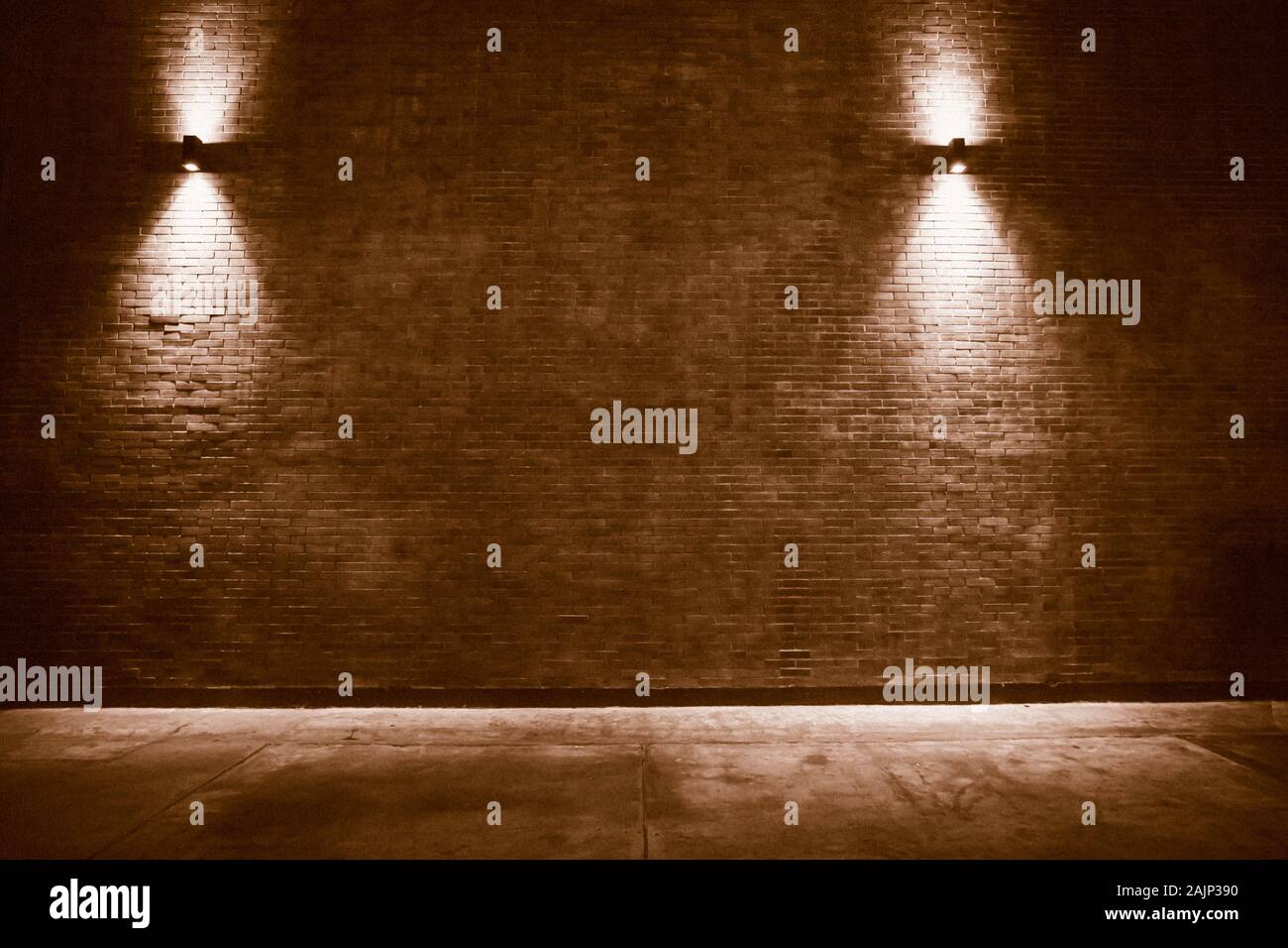 old room with brick wall, grungy background . brick wall with bulb lights lamp. nice brick show room with spotlights. Background of an empty corridor Stock Photo