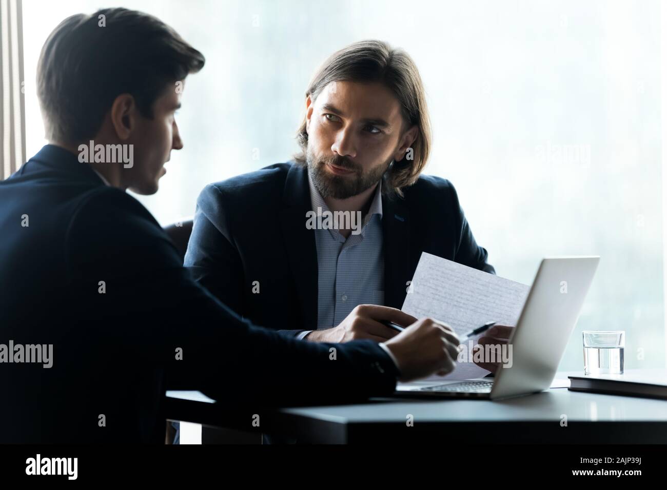 Male executive using laptop colleagues hi-res stock photography and ...