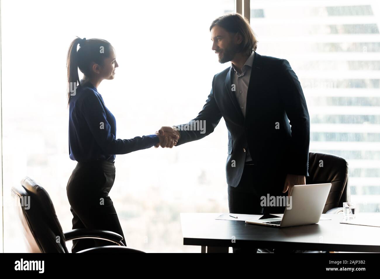 Diverse businesspeople handshake closing deal at meeting Stock Photo