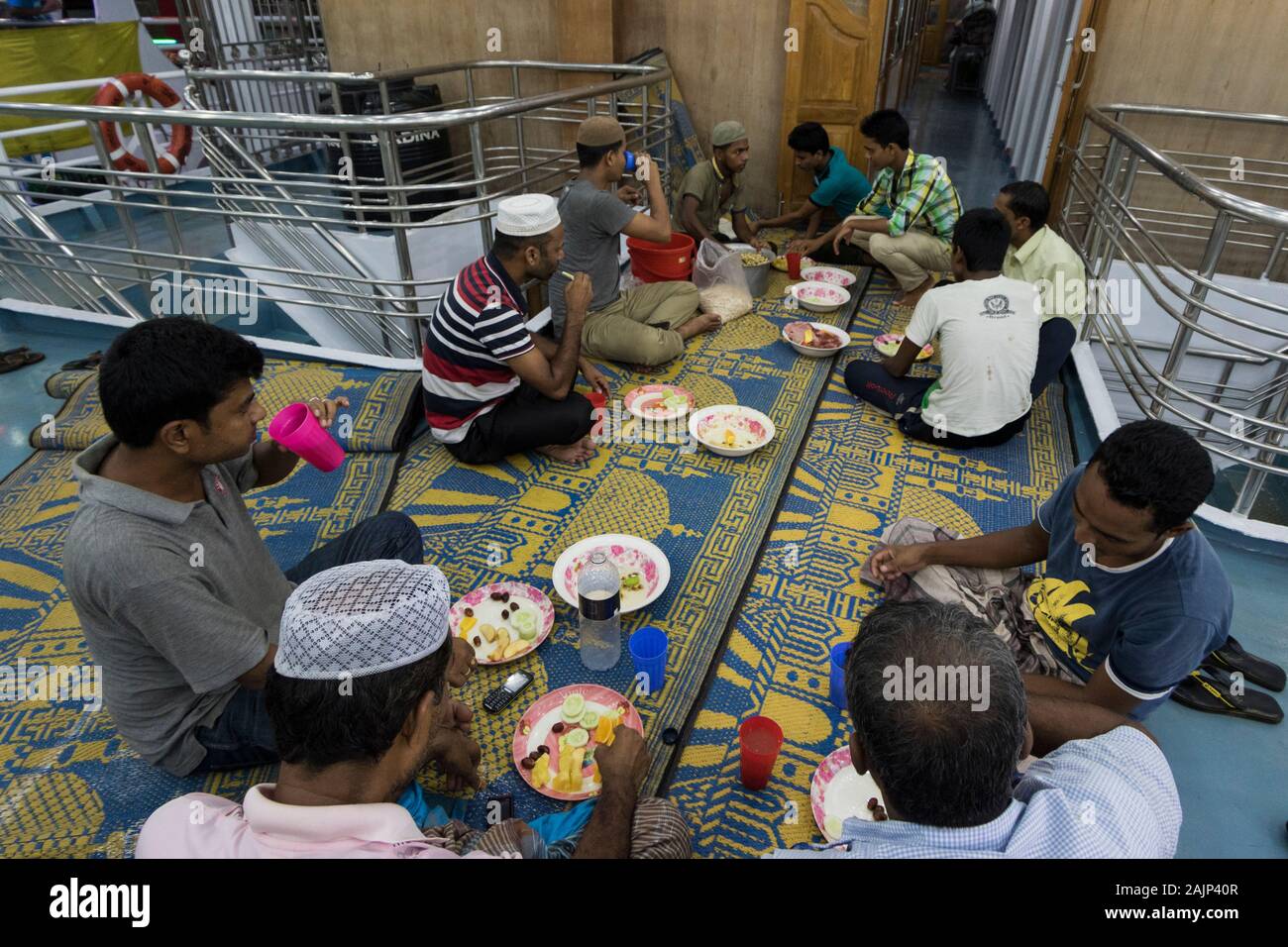 Bangladeshi Muslim devotees prepare Iftar on a vessel at Shadarghat Launch Terminal in Dhaka during the holy month of Ramadan. Bangladesh. Stock Photo