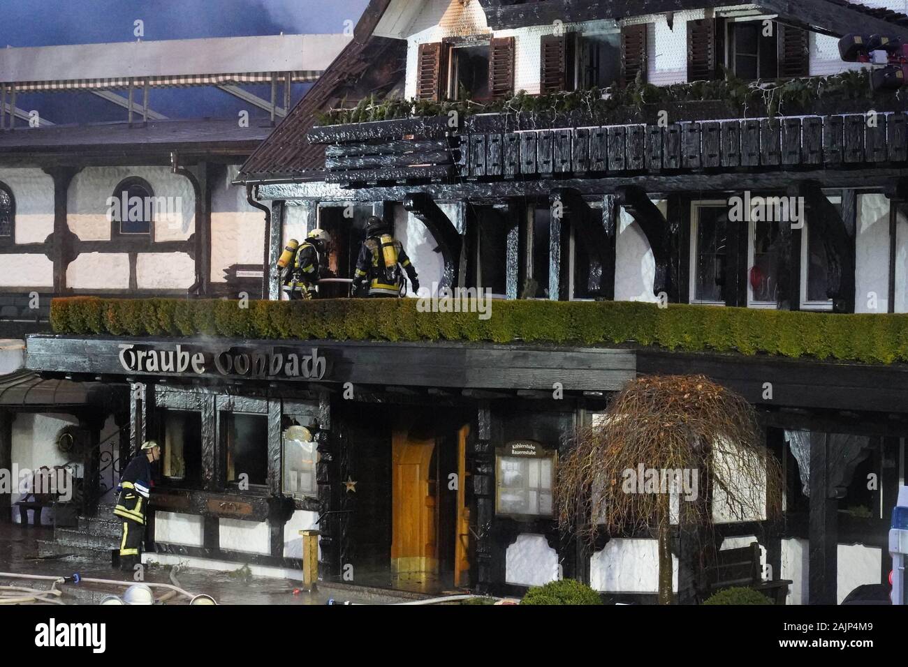 Baiersbronn, Germany. 05th Jan, 2020. Fire brigade personnel extinguish a  fire in the old building of the restaurant in the hotel "Traube Tonbach".  According to police reports, the fire in the three-star