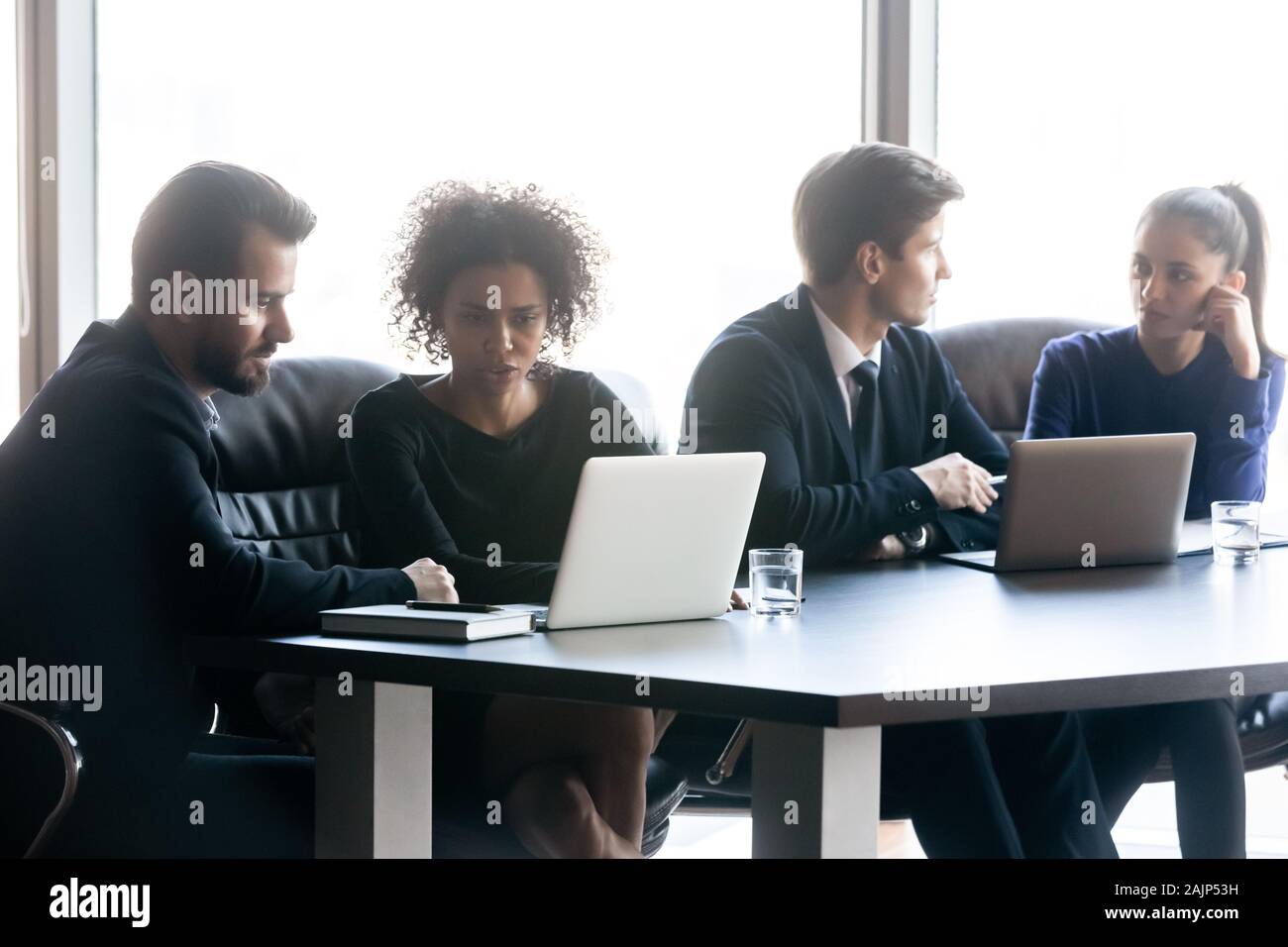 Multiracial businesspeople work together collaborating at meeting Stock Photo