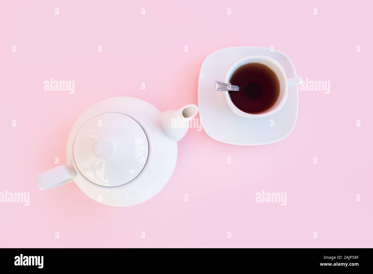 Tea time, brewing tea, cup of freshly brewed tea, warm soft and light, with pink background. Stock Photo