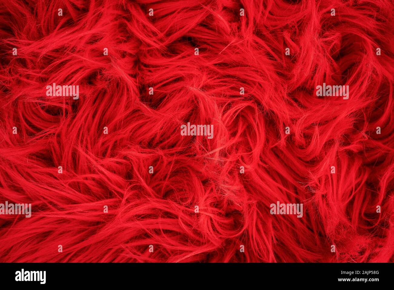 Shaggy carpet with wool material for backgrounds texture, close up of soft romantic pastel red and fluffy. Stock Photo