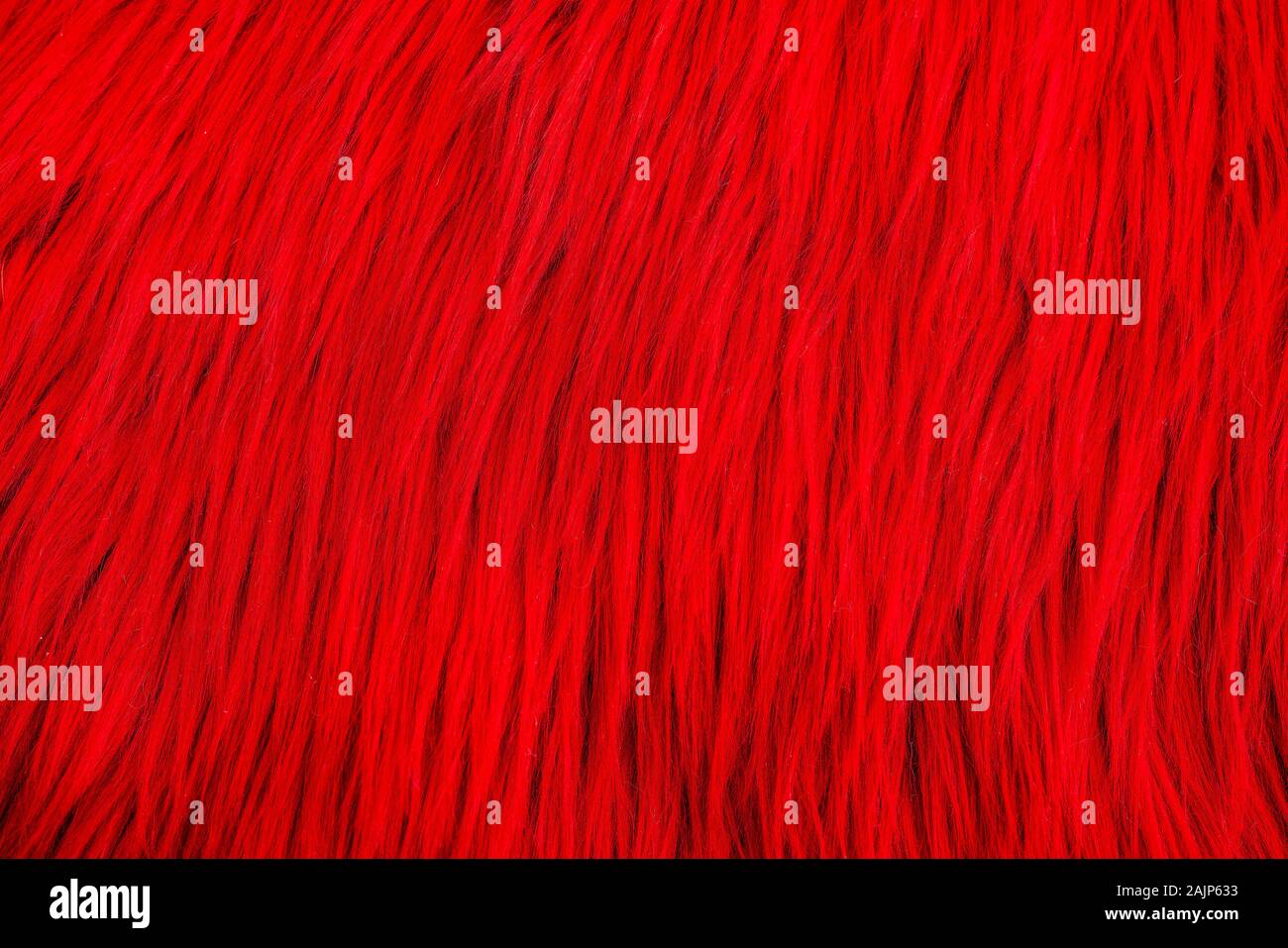 Shaggy carpet with wool material for backgrounds texture, close up of soft romantic pastel red and fluffy. Stock Photo