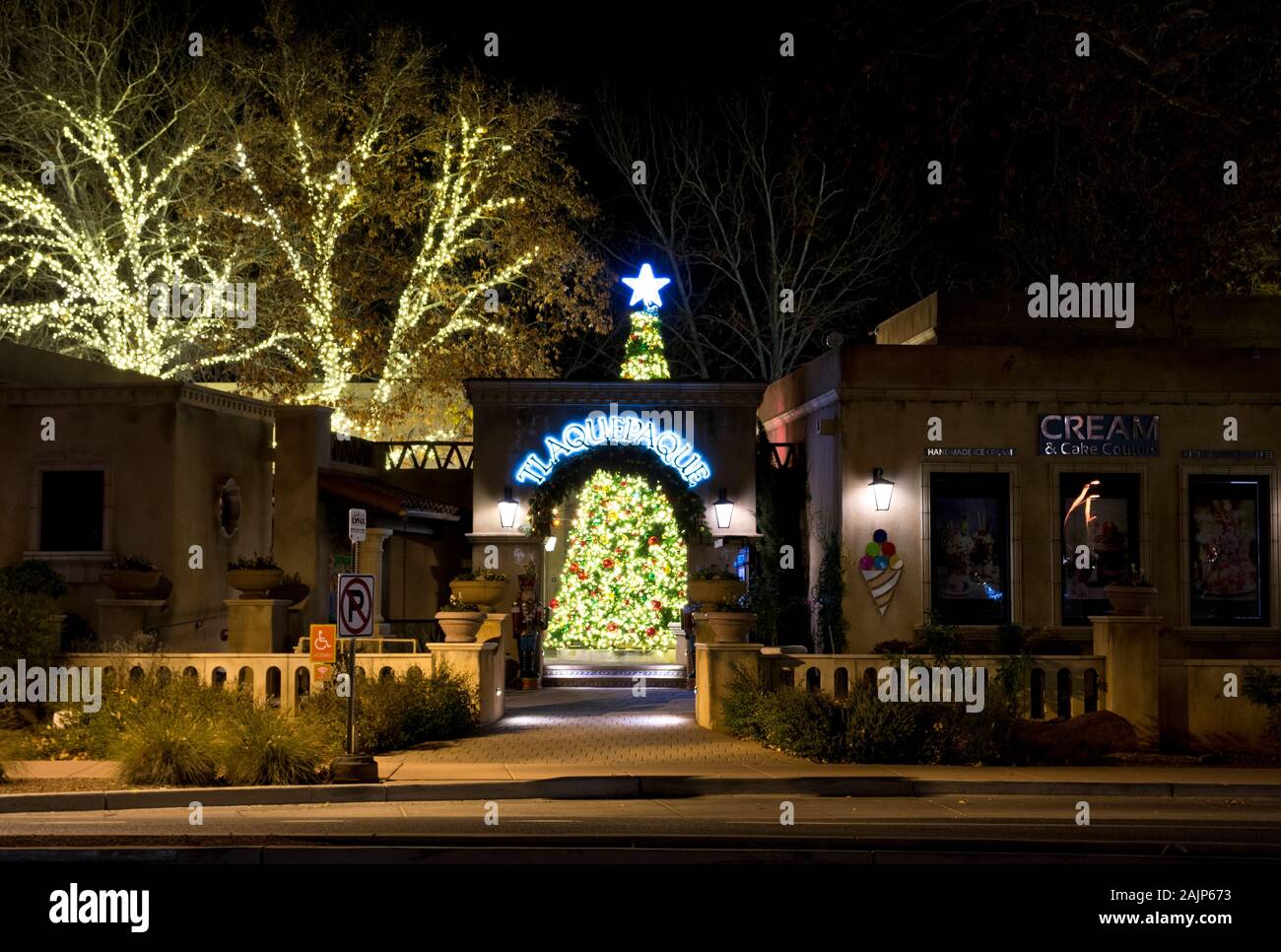 Illuminated trees and Christmas tree at Tlaquepaque North shopping village in Sedona Arizona at night. Stock Photo