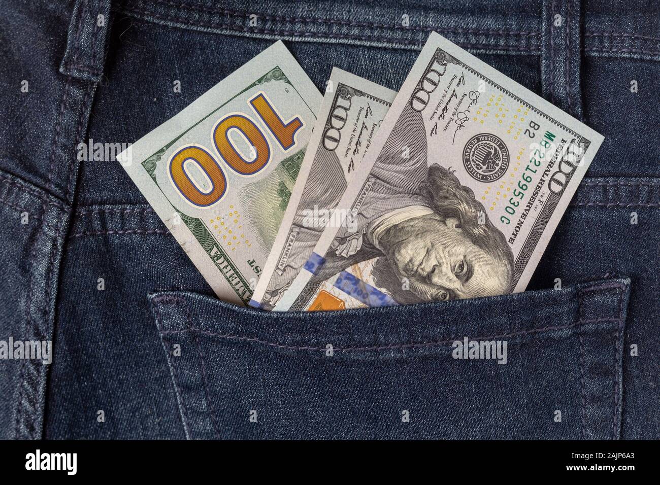 Many dollar 100 banknotes in a back jeans pocket Stock Photo
