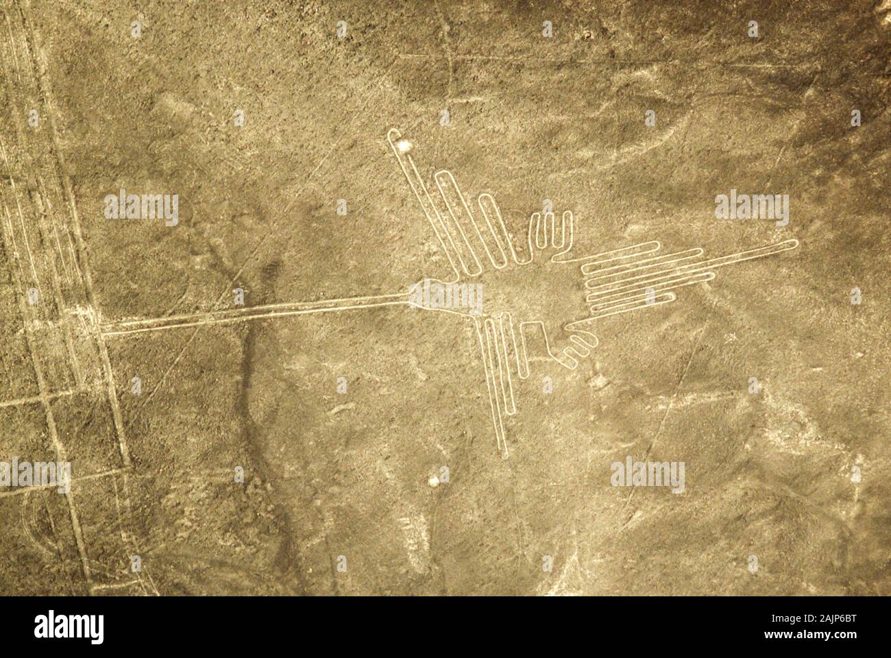 Aerial view of a hummingbird shape. The Nazca Lines are a group of very large geoglyphs formed by depressions or shallow incisions made in the soil of Stock Photo