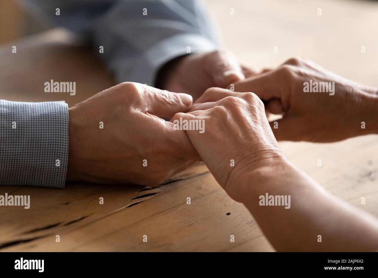 Older couple holding hands close up view Stock Photo