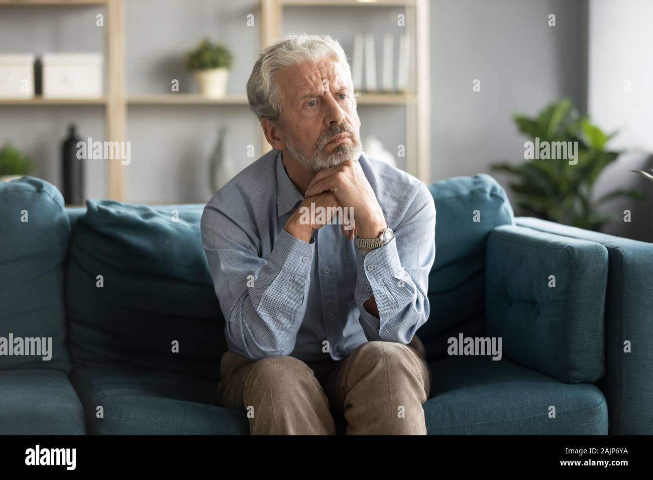 Pensive old man sitting alone hi-res stock photography and images - Alamy