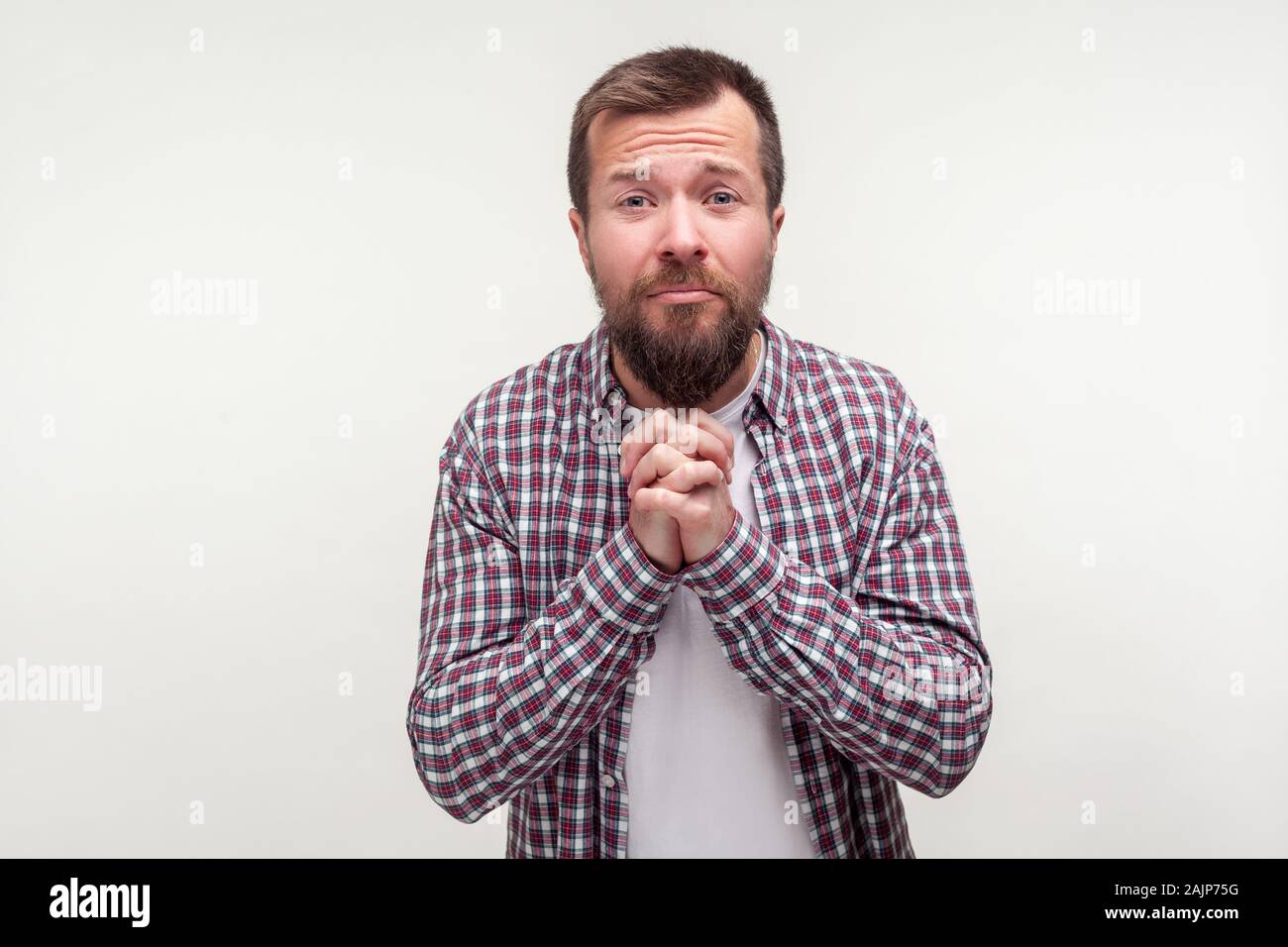 Please! Portrait of humble bearded young man in casual plaid shirt ...
