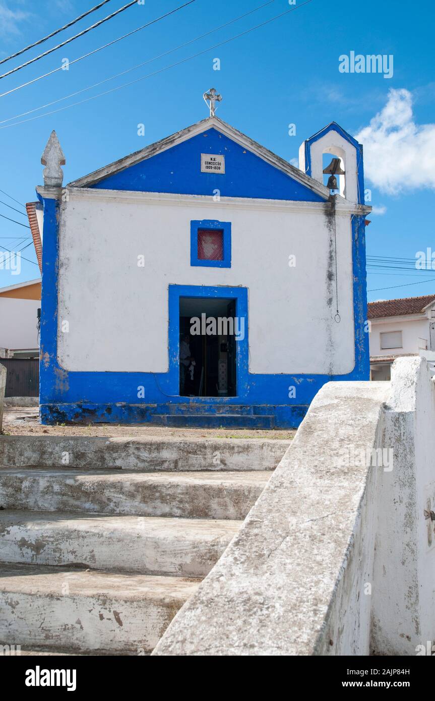 Quaint blue and white church line a street in a small town in the municipality of Obidos, Portugal Stock Photo