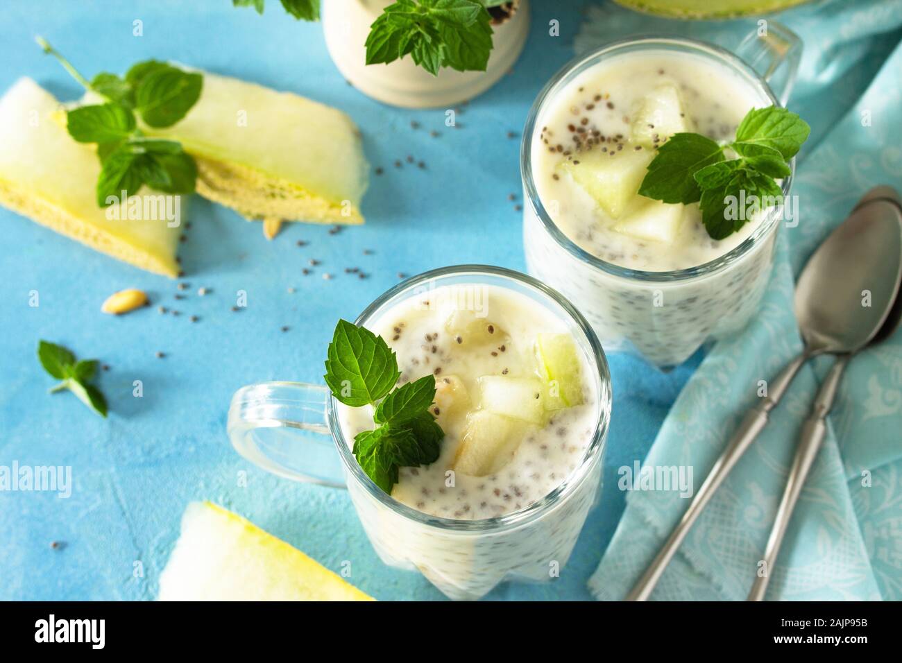 Healthy Pudding in a glass with Chia and melon and on blue stone  table. Healthy breakfast, vitamin snack, diet and healthy eating. Stock Photo