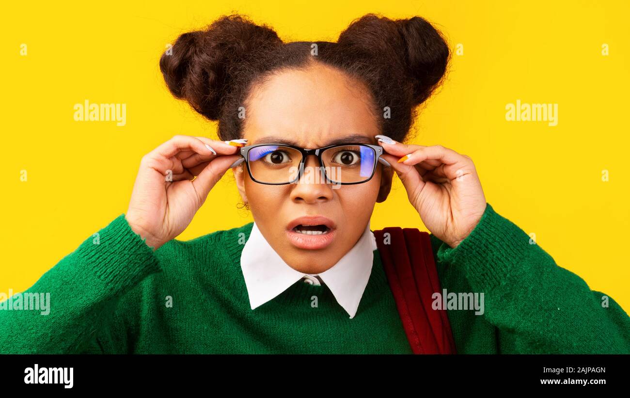 Unbelievable. Confused afro teenager with poor eyesight touching