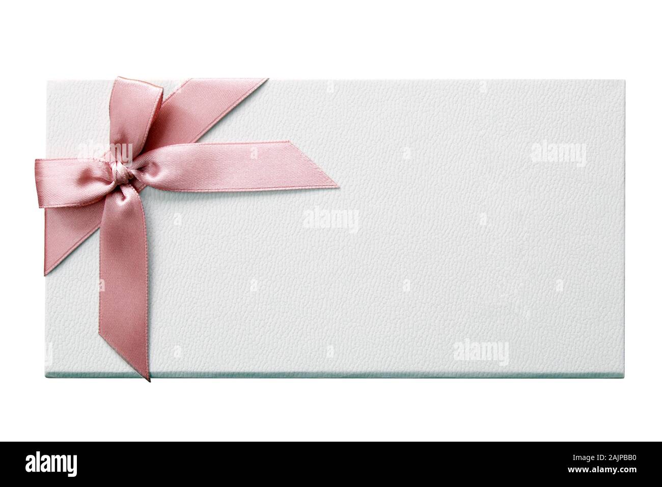 White gift box decorated with a pink bow on an isolated white background with a clipping path Stock Photo