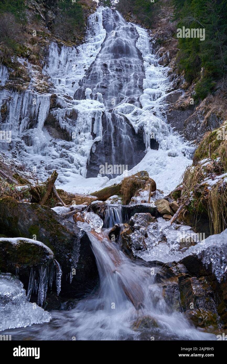 Winter landscape with mountain waterfall frozen on the edges Stock ...