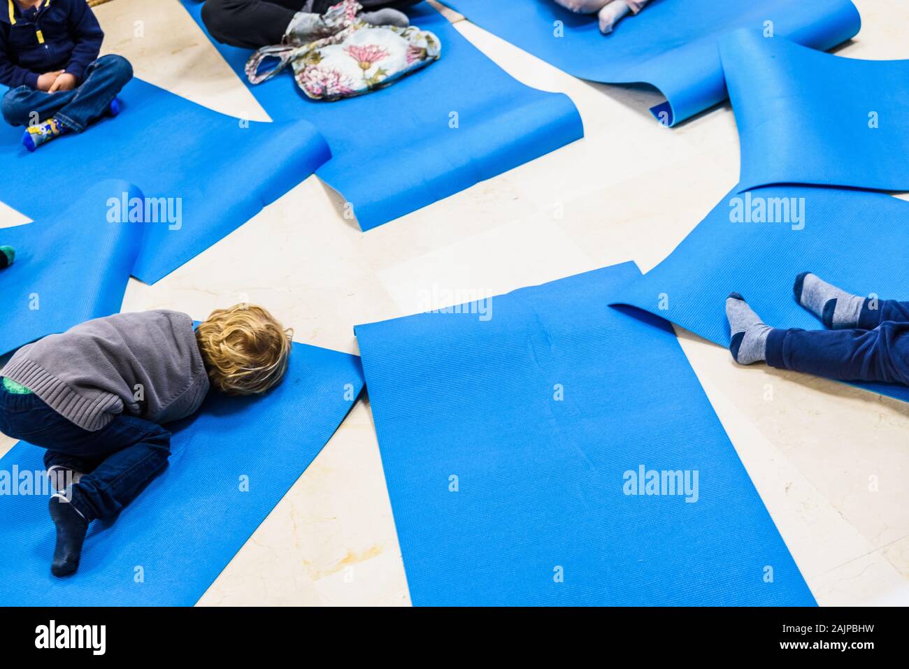 Group of children doing yoga exercises and relaxing on some mat Stock ...