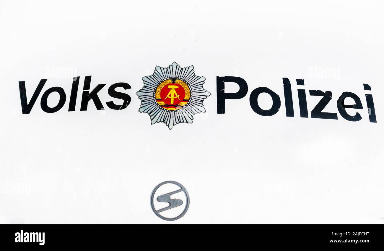 weathered volkspolizei, gdr police force, and trabant logo Stock Photo