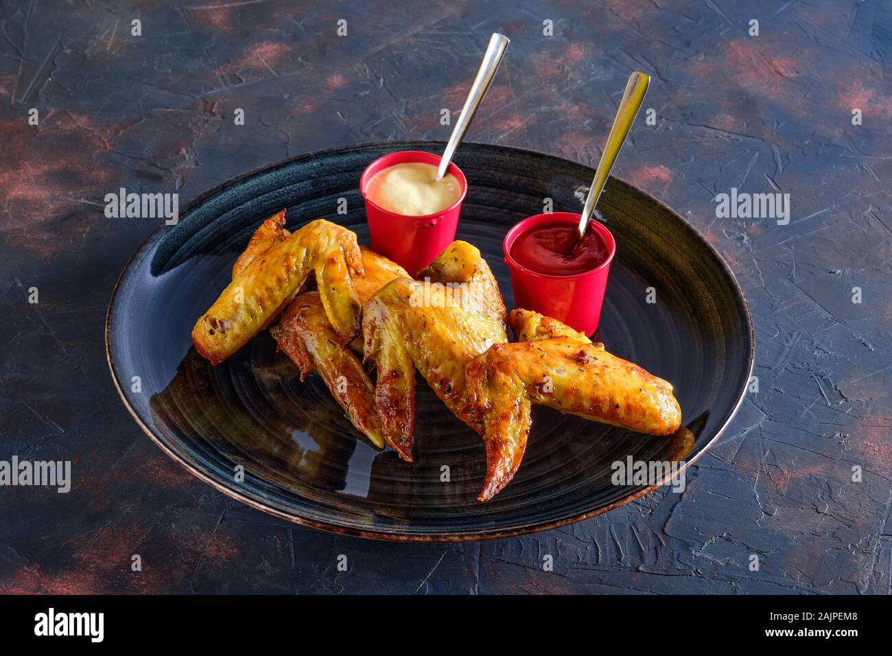 Roasted chicken wings with ketchup and mayonnaise Stock Photo Alamy
