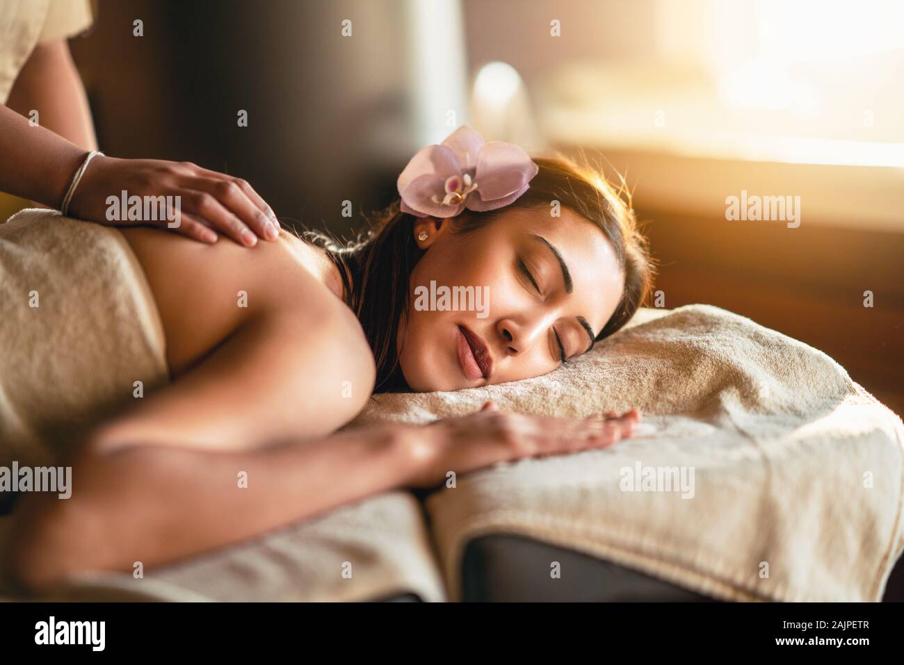 Happiness on woman's face having relaxing thai massage. Stock Photo