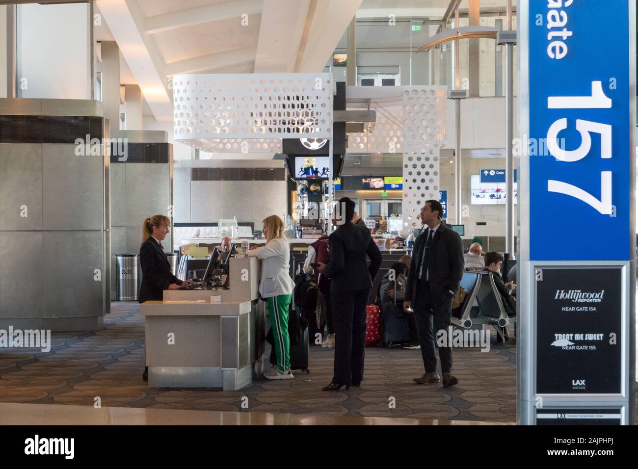 Person talking to the attendant at the gate desk in the airport Stock Photo