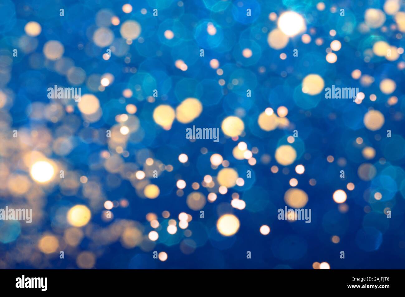 Blue festive background with sparkles in the bokeh. The concept of the celebration, the day of Christmas, New Year, birthday, ceremonies, events, etc. Stock Photo