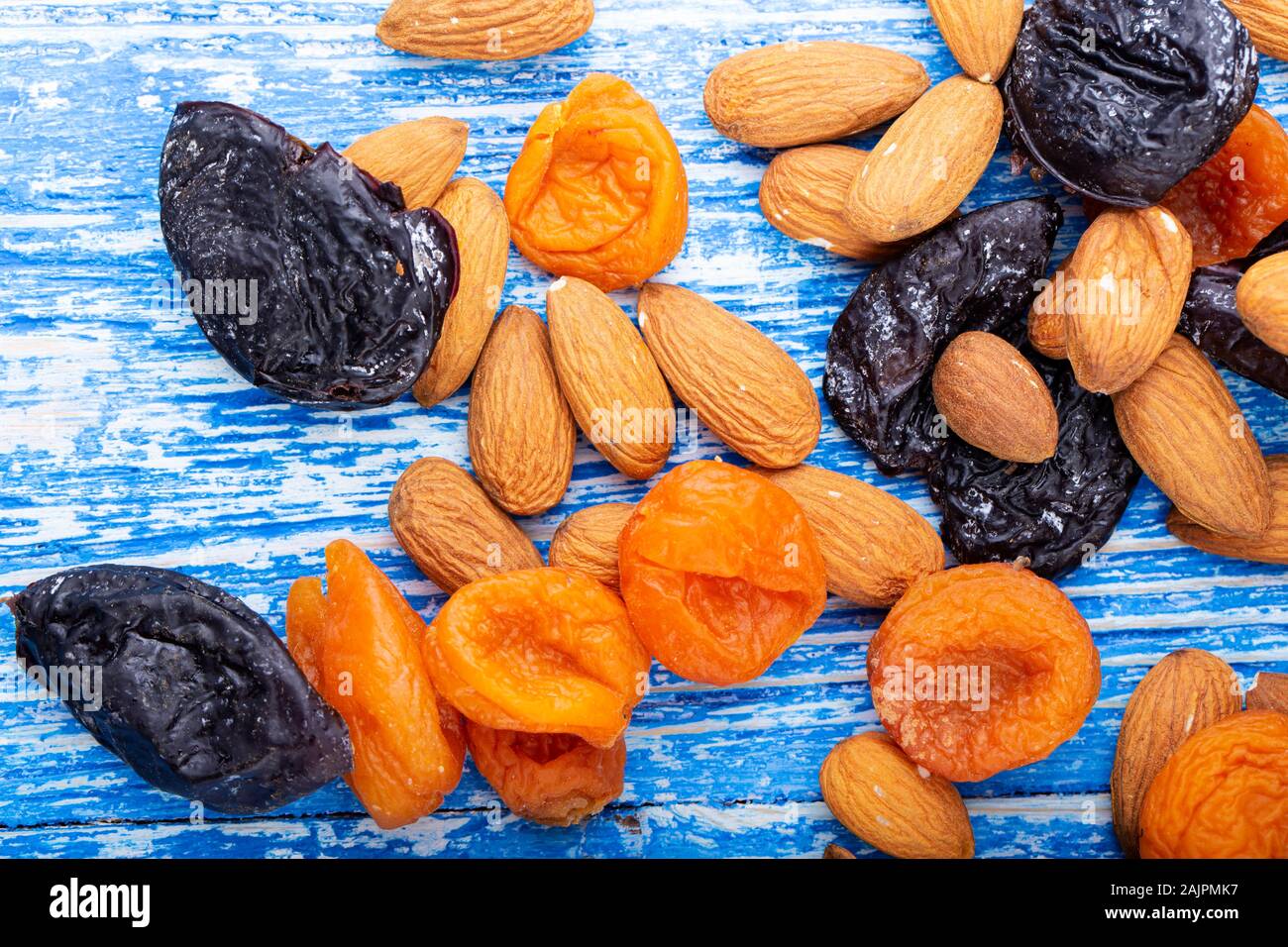 different dried fruits are scattered on the table. nutritious foods for