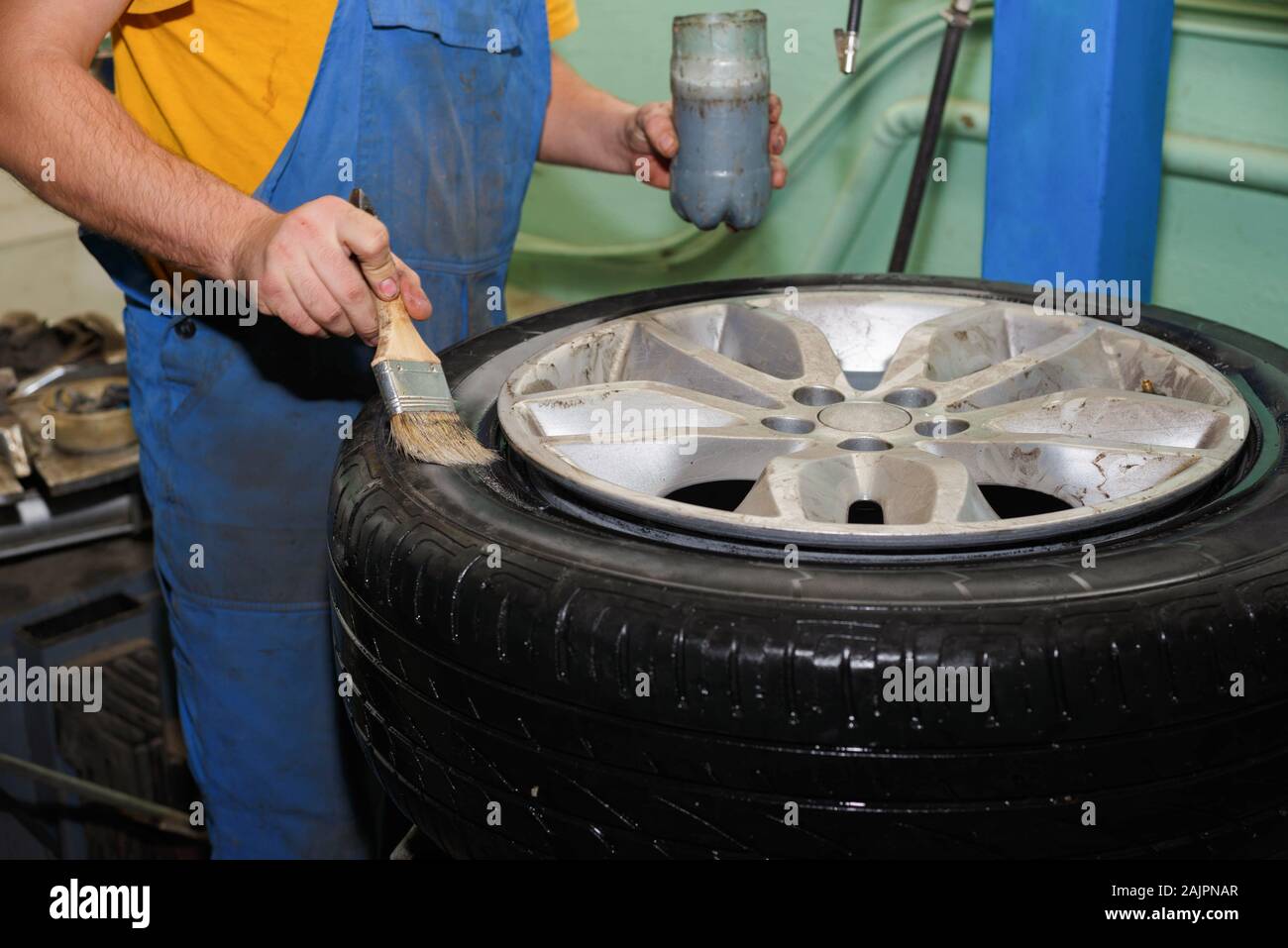 The master removes the tire from the cars drive Replacing a set of rubber before the season. Stock Photo